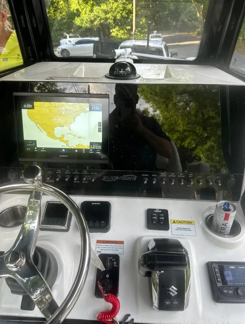 Slide: The Image of 2024 Blue Wave 2600 Makaira boat dashboard with navigation system and controls. - 4