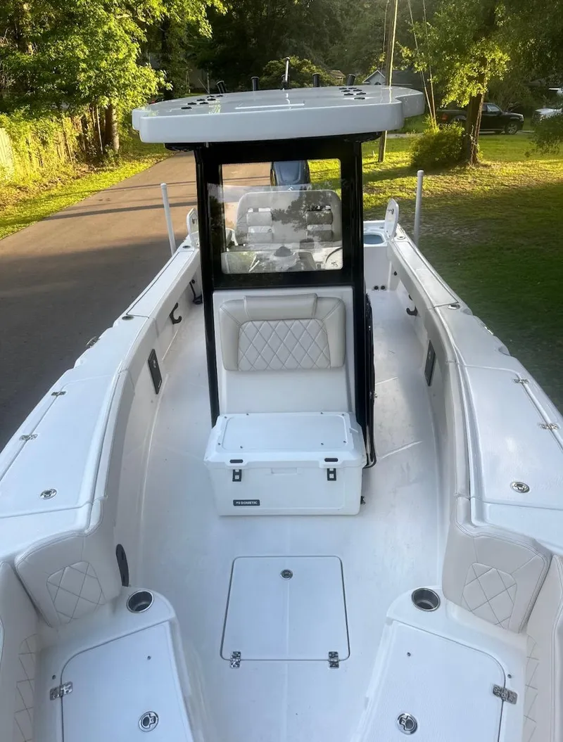 Slide: The Image of 2024 Blue Wave 2600 Makaira boat, spacious deck, sleek design, outdoor setting. - 5