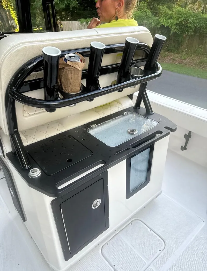 Slide: The Image of 2024 Blue Wave 2600 Makaira boat console with rod holders and storage. - 7