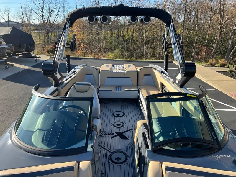 Slide: The Image of 2024 MasterCraft XStar S boat interior with open seating and wakeboard tower. - 11