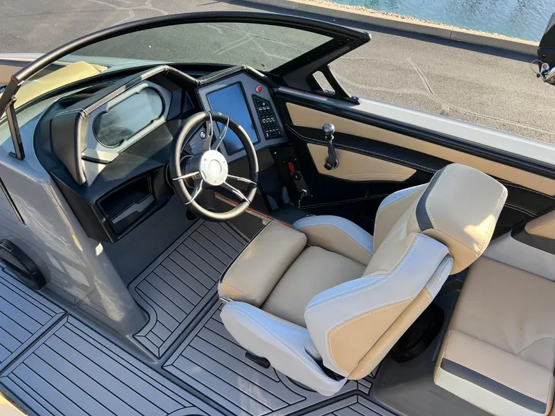 Slide: The Image of 2024 MasterCraft XStar S boat interior with modern dashboard and comfortable seating. - 12