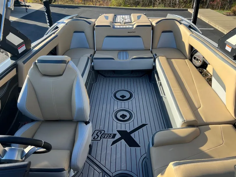 Slide: The Image of 2024 MasterCraft XStar S interior with beige seating and sleek design. - 15
