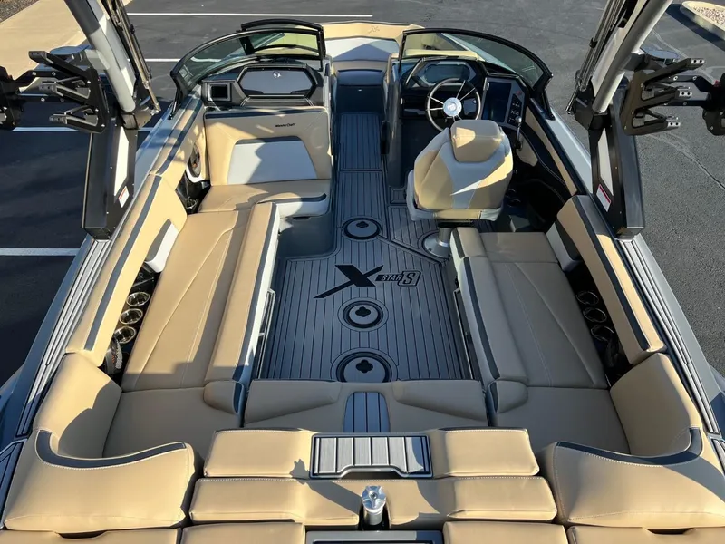 Slide: The Image of 2024 MasterCraft XStar S boat interior with beige seating and sleek design. - 20