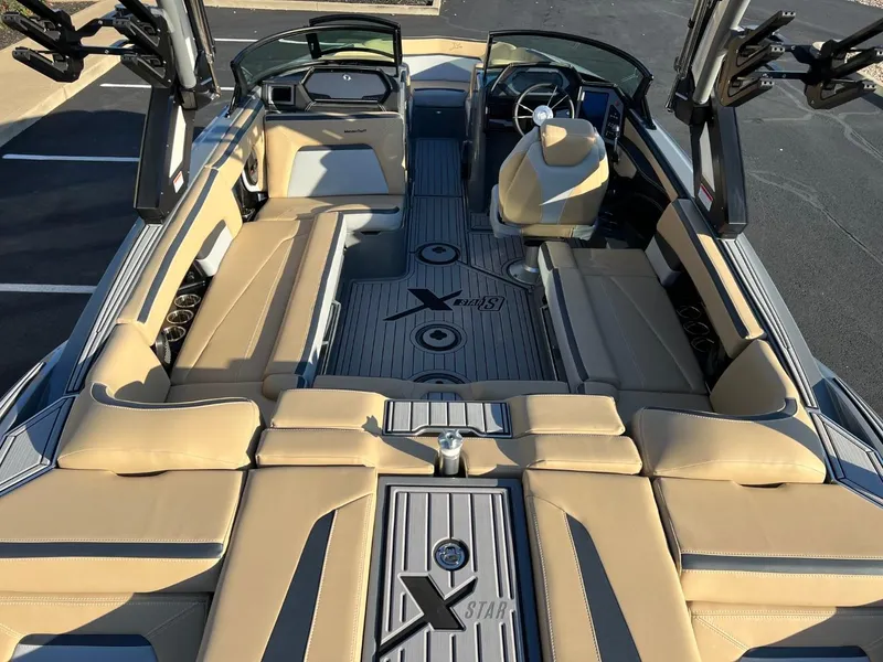 Slide: The Image of 2024 MasterCraft XStar S interior with beige seating and sleek design. - 21