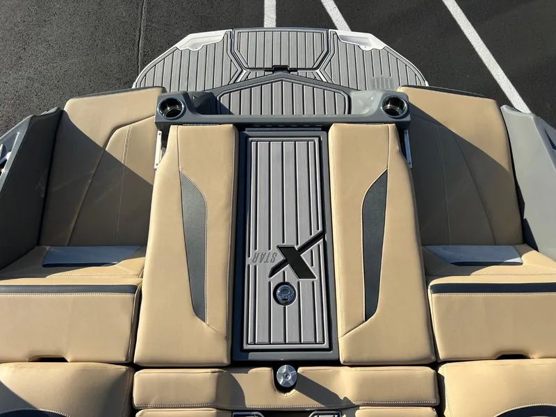Slide: The Image of 2024 MasterCraft XStar S boat interior with tan and gray seating. - 24
