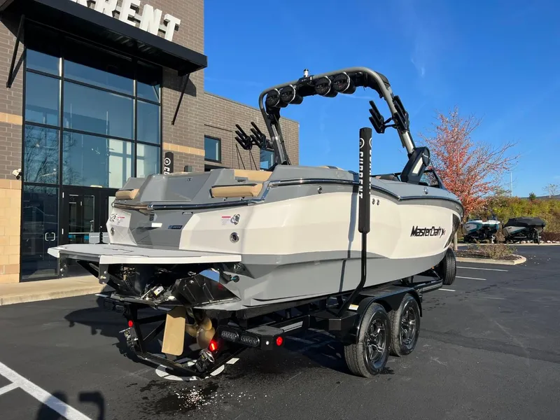 Slide: The Image of 2024 MasterCraft XStar S boat on trailer outside dealership. - 4