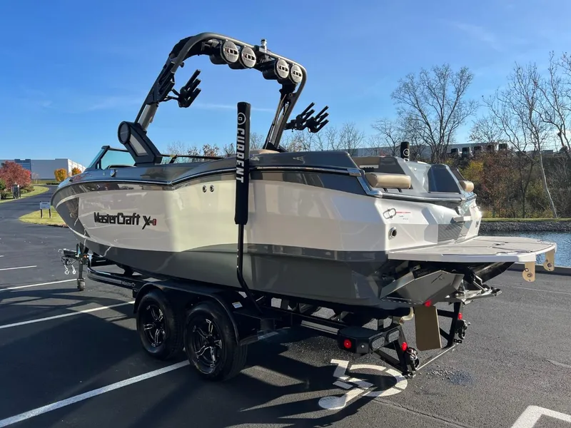 Slide: The Image of 2024 MasterCraft XStar S boat on trailer in parking lot. - 6