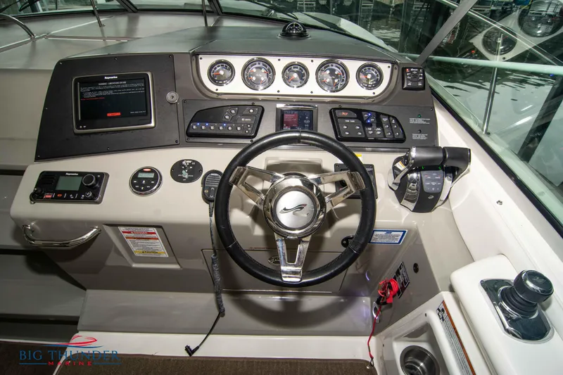 Slide: The Image of 2016 Sea Ray 370 Sundancer helm with modern controls and navigation instruments. - 22