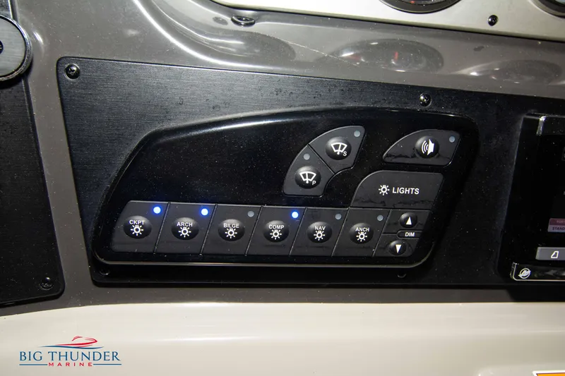 Slide: The Image of Control panel of 2016 Sea Ray 370 Sundancer boat with light and function switches. - 28