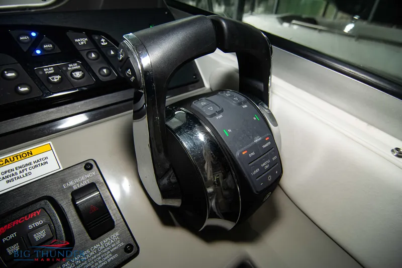 Slide: The Image of Close-up of 2016 Sea Ray 370 Sundancer boat throttle controls. - 35
