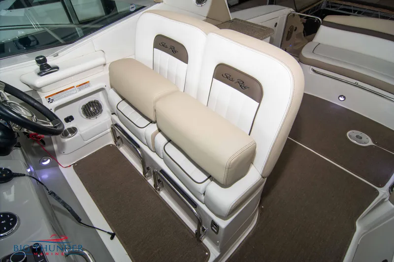 Slide: The Image of Interior seating of 2016 Sea Ray 370 Sundancer boat, featuring plush white and beige upholstery. - 37