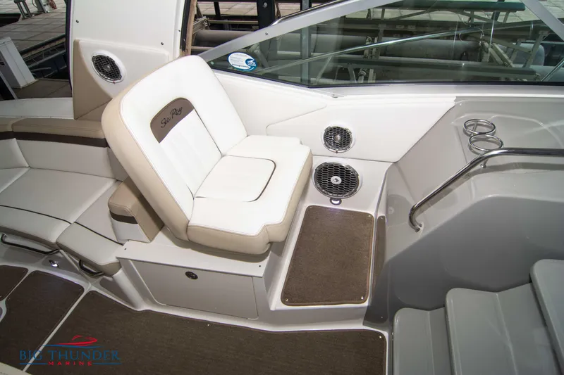 Slide: The Image of 2016 Sea Ray 370 Sundancer interior seating with speakers and cup holders. - 39