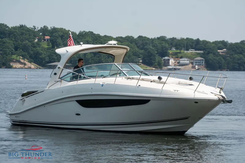 Slide: The Image of 2016 Sea Ray 370 Sundancer yacht cruising on a serene lake. - 4