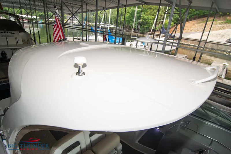 Slide: The Image of 2016 Sea Ray 370 Sundancer yacht docked under a covered marina. - 46