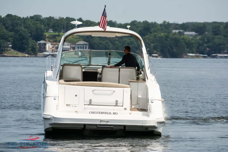 Slide: The Image of 2016 Sea Ray 370 Sundancer cruising on a lake with American flag. - 7