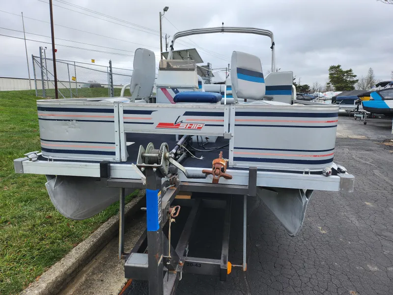 Slide: The Image of 1991 Grumman Fish N Fun 20' pontoon boat on trailer, parked outdoors. - 6