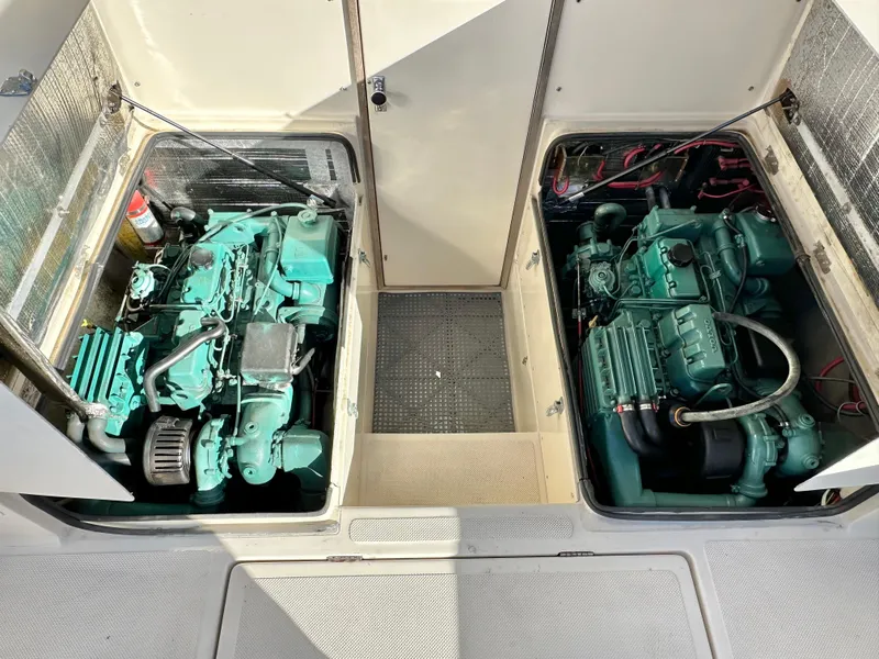 Slide: The Image of 1994 Precision 28 Convertible engine compartment with twin marine engines. - 14