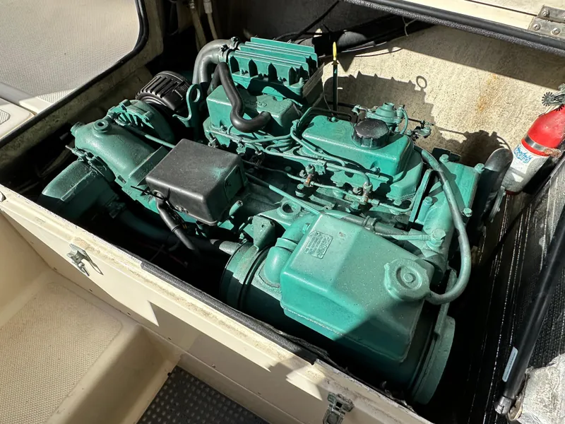 Slide: The Image of Engine compartment of a 1994 Precision 28 Convertible boat, featuring a green engine. - 15