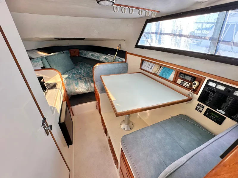 Slide: The Image of Interior of 1994 Precision 28 Convertible boat with dining area and sleeping quarters. - 17