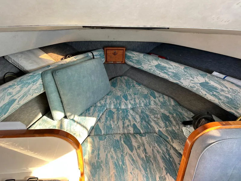 Slide: The Image of Interior of 1994 Precision 28 Convertible boat with patterned cushions and wooden accents. - 21