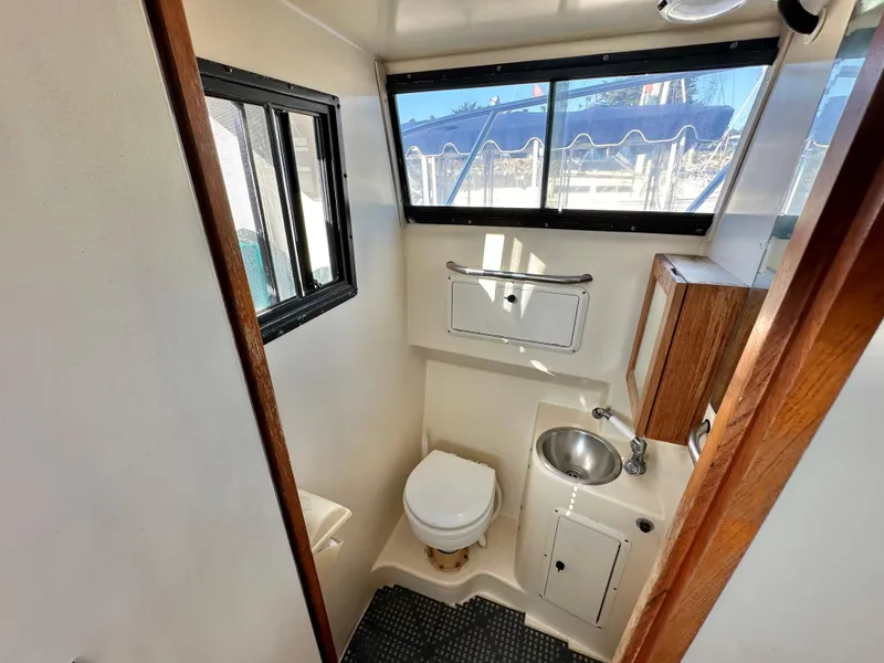 Slide: The Image of Compact bathroom in 1994 Precision 28 Convertible boat with toilet, sink, and window. - 22