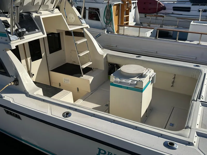 Slide: The Image of 1994 Precision 28 Convertible boat with open deck and ladder in marina. - 4