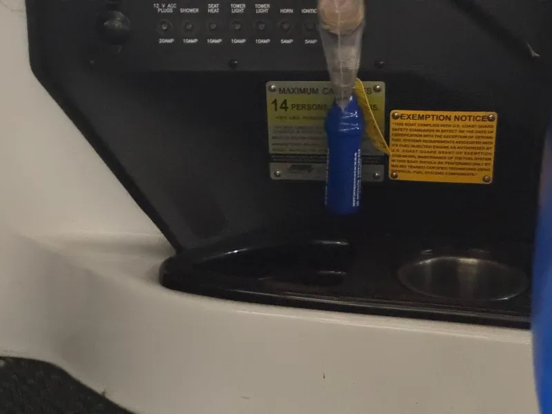 Slide: The Image of 2015 Malibu Wakesetter 22 MXZ interior, capacity label for 14 persons, safety notices visible. - 11