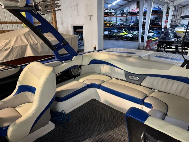 Slide: The Image of Interior of 2015 Malibu Wakesetter 22 MXZ boat with blue and white seating. - 13