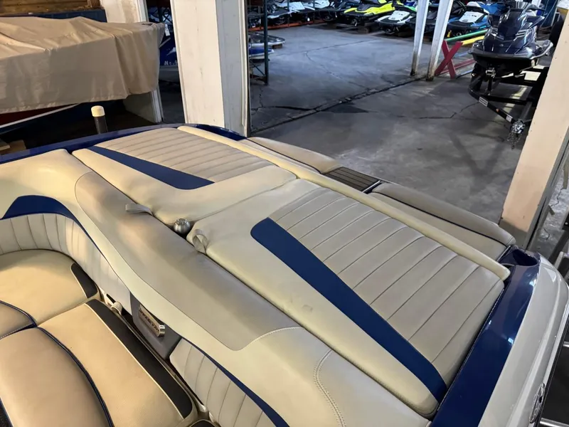 Slide: The Image of 2015 Malibu Wakesetter 22 MXZ interior with blue and white upholstery in a storage area. - 14