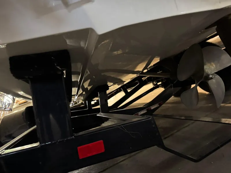 Slide: The Image of 2015 Malibu Wakesetter 22 MXZ boat underside with propeller and trailer. - 20