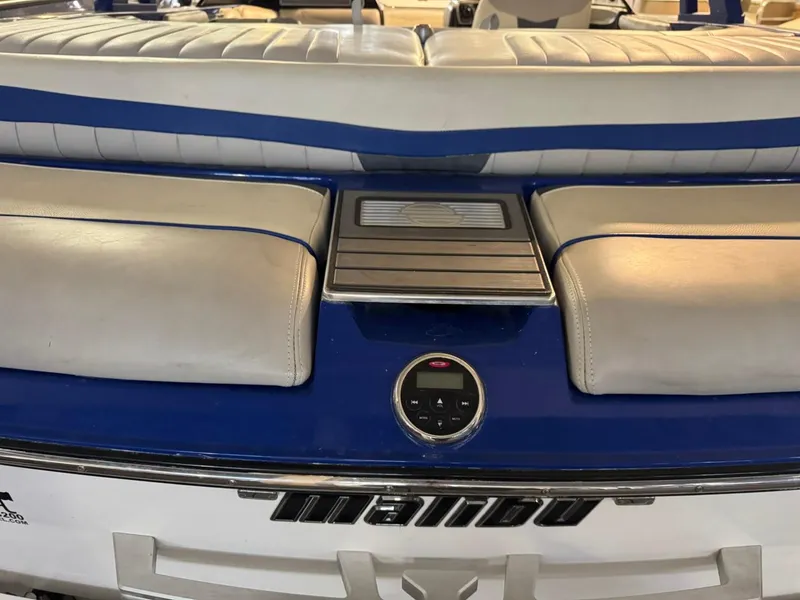 Slide: The Image of 2015 Malibu Wakesetter 22 MXZ boat interior with blue and white seating. - 21