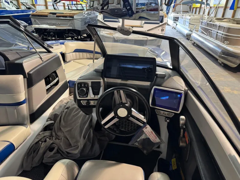 Slide: The Image of Interior of 2015 Malibu Wakesetter 22 MXZ boat with modern dashboard and steering wheel. - 23