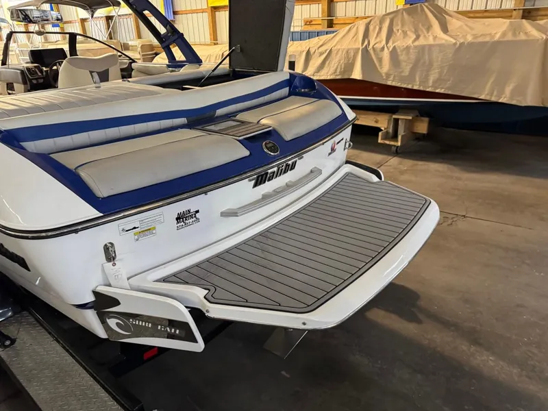 Slide: The Image of 2015 Malibu Wakesetter 22 MXZ boat with swim platform in a storage facility. - 25