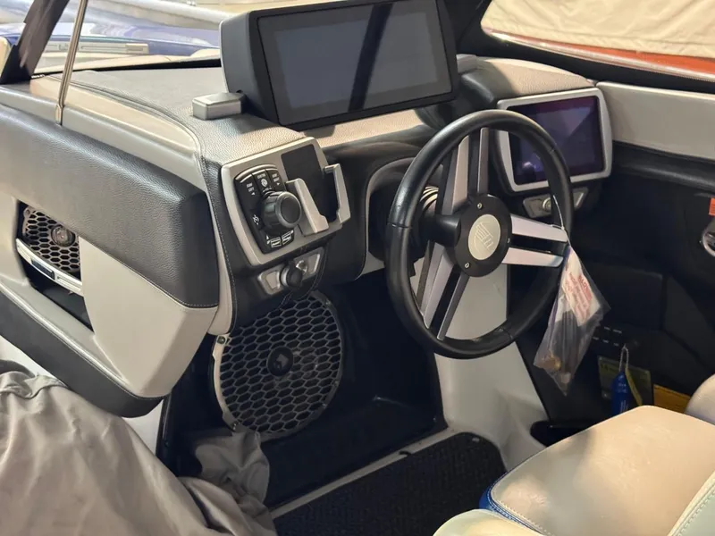 Slide: The Image of 2015 Malibu Wakesetter 22 MXZ interior with modern dashboard and steering wheel. - 27