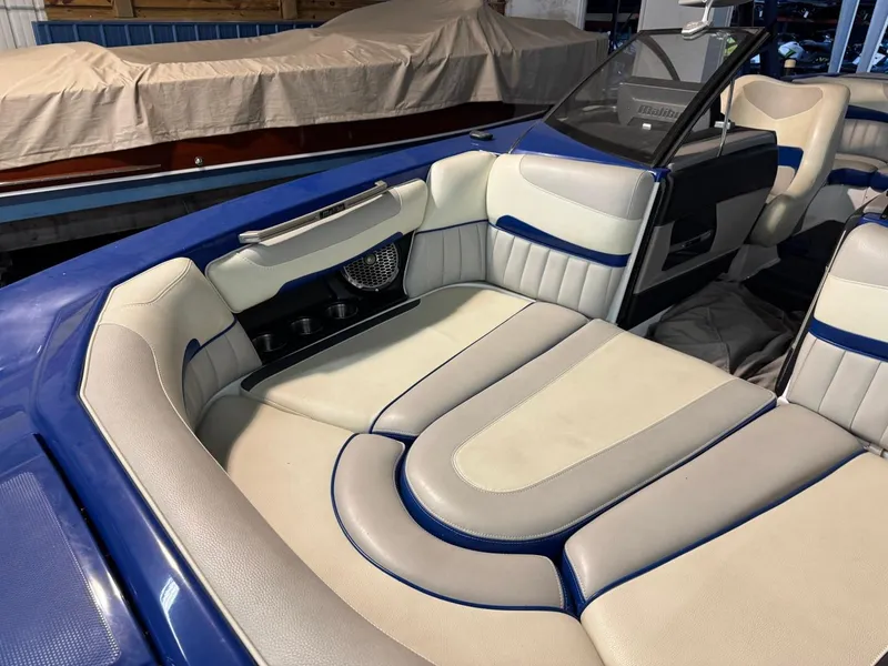 Slide: The Image of 2015 Malibu Wakesetter 22 MXZ interior with blue and beige seating. - 3
