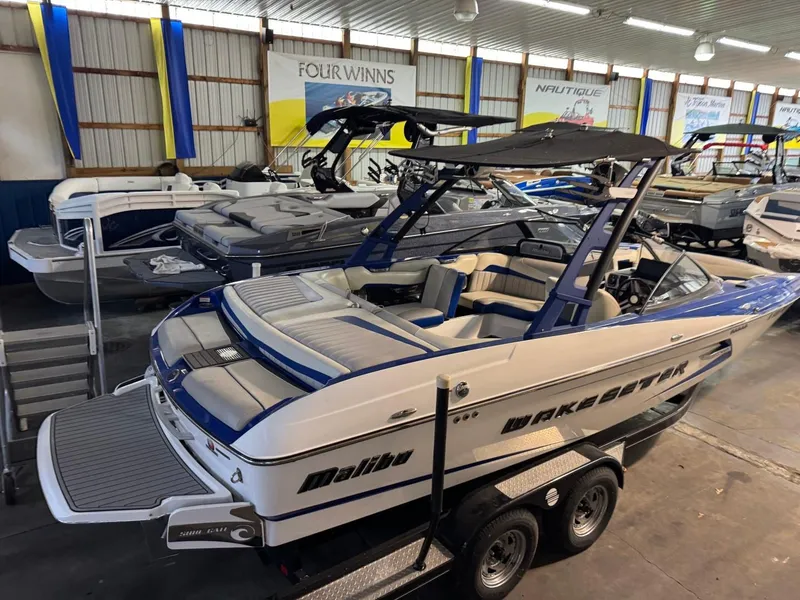 Slide: The Image of 2015 Malibu Wakesetter 22 MXZ boat in showroom, blue and white design. - 31