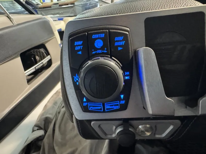 Slide: The Image of 2015 Malibu Wakesetter 22 MXZ control panel with illuminated buttons and dial. - 33