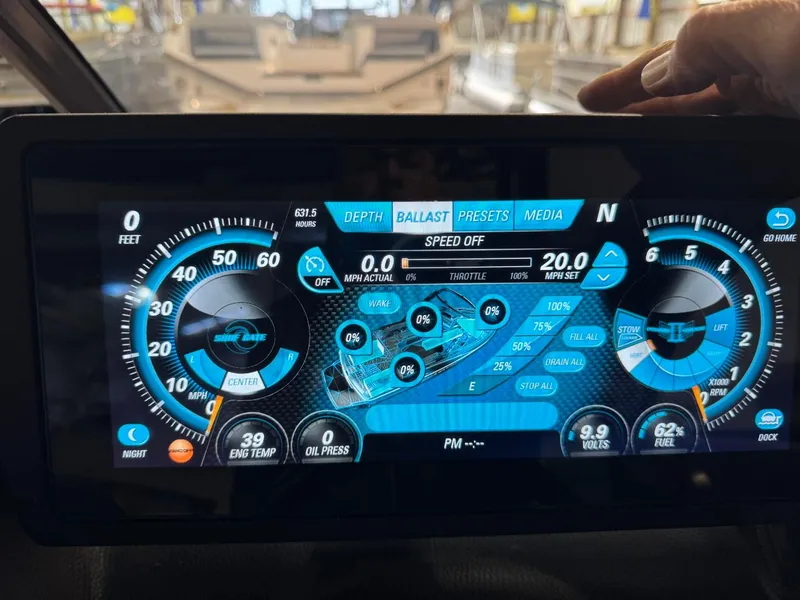 Slide: The Image of Dashboard of a 2015 Malibu Wakesetter 22 MXZ boat with digital controls and gauges. - 38