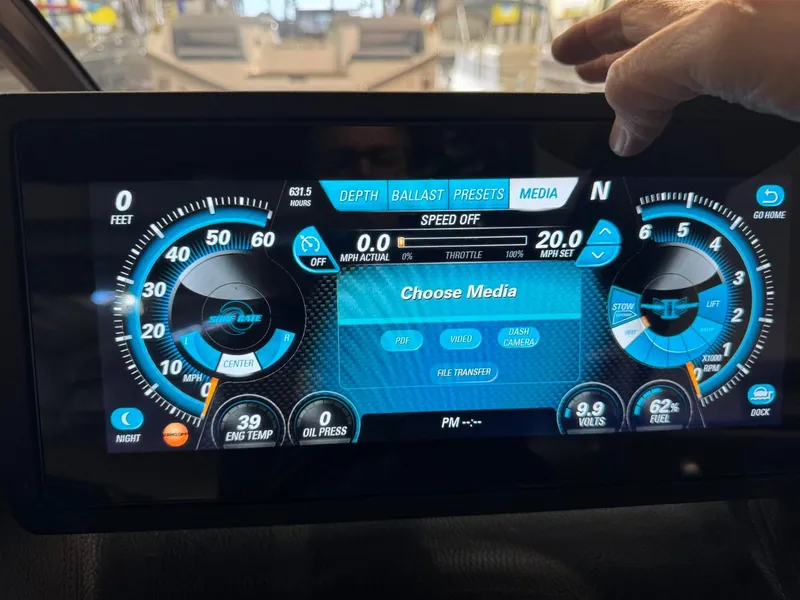 Slide: The Image of Dashboard display of a 2015 Malibu Wakesetter 22 MXZ boat, showing speed and media controls. - 40