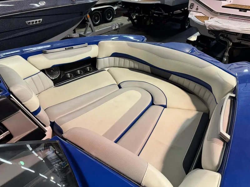 Slide: The Image of 2015 Malibu Wakesetter 22 MXZ interior with blue and beige seating. - 5