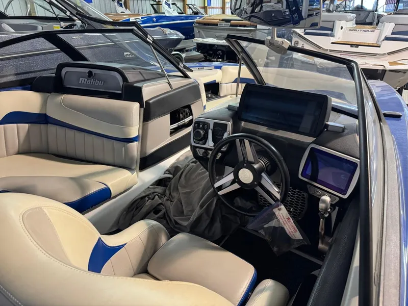 Slide: The Image of 2015 Malibu Wakesetter 22 MXZ interior with modern dashboard and seating. - 8