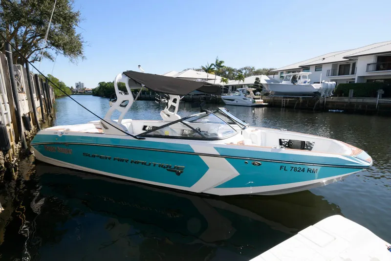 The Image of 2017 Nautique Super Air Nautique G25 boat docked on calm water. - 0