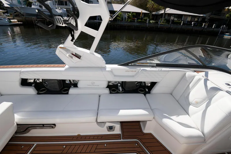 Slide: The Image of 2017 Nautique Super Air Nautique G25 interior with white seating and teak flooring. - 11