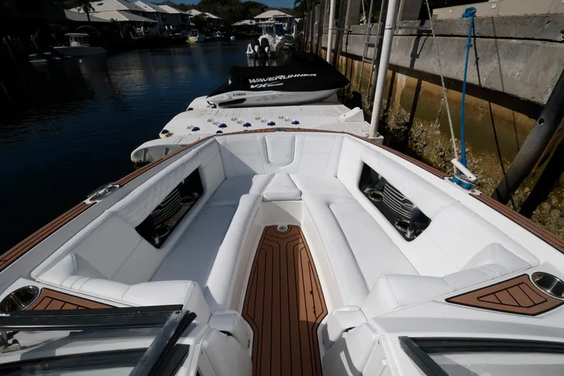 Slide: The Image of 2017 Nautique Super Air Nautique G25 interior with white seating and wooden flooring. - 12