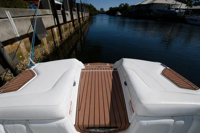 Slide: The Image of 2017 Nautique Super Air Nautique G25 boat with white interior and wooden deck. - 14