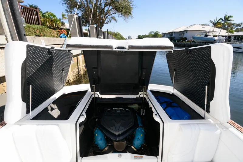Slide: The Image of 2017 Nautique Super Air Nautique G25 engine compartment open by the water. - 18