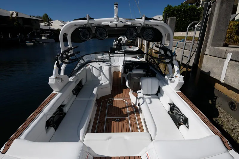 Slide: The Image of 2017 Nautique Super Air Nautique G25 boat docked on a sunny canal. - 3