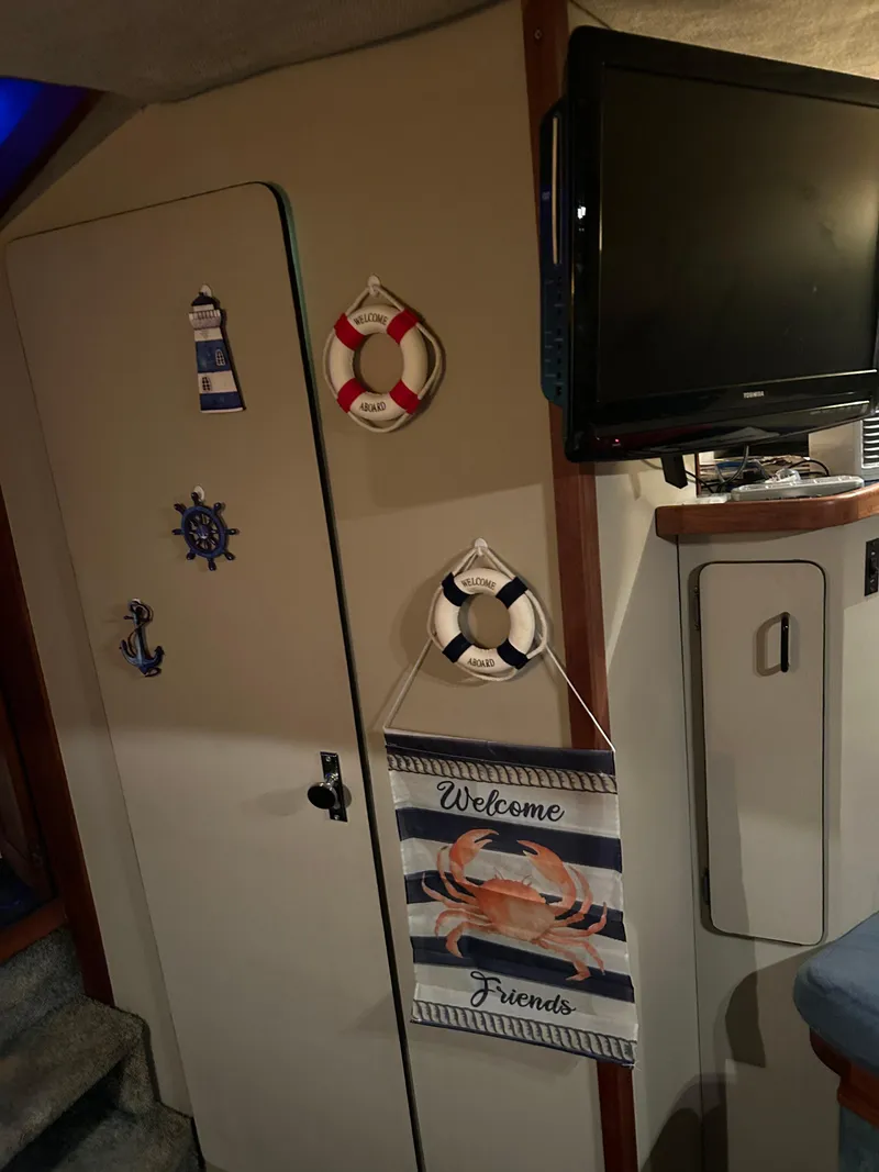 Slide: The Image of Interior of 1987 Carver Riviera 2807 with nautical decor and wall-mounted TV. - 14