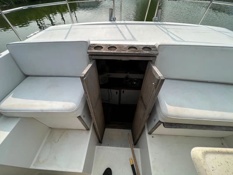 Slide: The Image of 1987 Carver Riviera 2807 boat interior with open cabin door and seating area. - 17