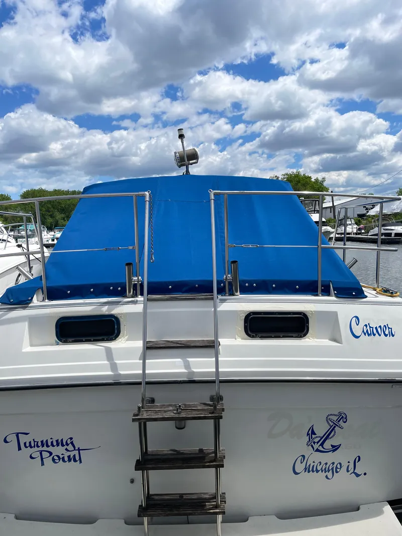 Slide: The Image of 1987 Carver Riviera 2807 boat docked, blue canopy, "Turning Point" and "Chicago IL" text. - 3